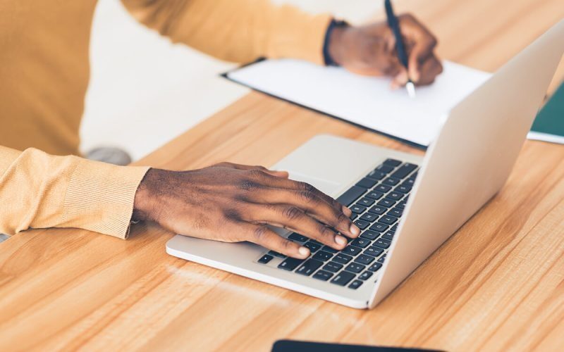 imgi_2_unrecognizable-black-guy-working-on-his-laptop-RF6ZCJQ-rbaoalcg68765knn83r39nwnkh0ppwytqbr3ixnpu0